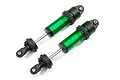Two Traxxas green anodized aluminium GT-Maxx shock absorbers without springs, shown against a white background.