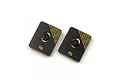 Two rectangular Yeah Racing 10g brass chassis balancing weights with black coating and central mounting holes.