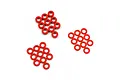 A collection of small red anodized aluminium flat washers arranged in three loose groups on a white background.