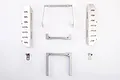 A set of silver metal RC mounting parts for the Killerbody SCX10 II, including side plates, brackets, and small clips laid out on a white background.