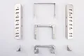 A set of silver metal RC mounting parts including two long side panels, two U-shaped brackets, and two small corner mounts on a white background.