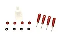 A set of four red anodized aluminium shock absorbers with associated small parts and a bottle of shock oil on a white background.