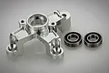 A silver aluminium clutch tripod mount for an RC car, shown with two ball bearings on a white background.