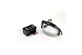 Artesania Latina hands-free magnifying headset with LED light, a storage case for interchangeable lenses, and two batteries on a white background.
