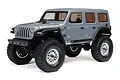 A studio shot of the grey Axial SCX24 Jeep Wrangler JLU 1/24 scale RC rock crawler, showing the side and front profile against a white background.