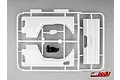 A white plastic parts tree for a 1/10 scale RC car, including rear fender skirts and a Jeep-branded panel, with one small black component.