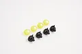 A set of four yellow translucent spotlight lenses and four black plastic spotlight housing cups for an RC vehicle.