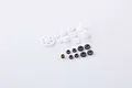 A collection of various small plastic and metal gears for an RC vehicle transmission set, arranged on a white background.