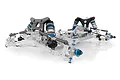 Team Associated RC10 B6.4CC Collectors Clear Edition buggy chassis showing transparent plastic parts, blue anodized aluminum accents, and carbon fiber shock towers.