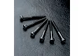 Six black metal cap head screws arranged in a fan shape on a textured black surface.