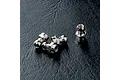 Four silver metal pivot balls for RC cars arranged on a black textured surface.