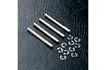 Four silver metal RC shock shafts and a collection of small metal E-clips arranged on a black textured surface.