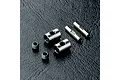 MST CVD rebuild kit parts including two metal barrels, two pins, and two grub screws on a black textured surface.