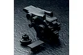 Black plastic MST rear gearbox casing set components on a textured black surface.