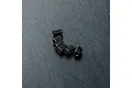Six small black metal grub screws arranged in a slight curve on a textured black surface.