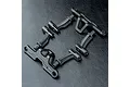 A set of black plastic MST battery mount components arranged on a textured black surface.