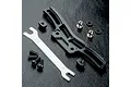MST black aluminium front shock mount set with adjustment tool and included hardware on a black textured surface.