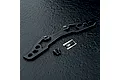 MST black lightweight aluminium bumper support for RC cars, including two screws and an MST logo sticker on a dark textured surface.