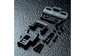 MST RRX conversion kit parts including molded plastic chassis components, screws, spacers, and washers arranged on a dark textured surface.