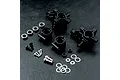 MST black aluminium rear hub set for RC cars, including hubs, bearings, screws, ball studs, and washers on a textured black surface.