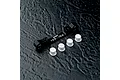 MST black aluminium adjustable suspension arm mount with four white plastic inserts on a dark textured surface.