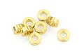 A group of eight small brass-coloured metal oilite bushings arranged on a white background.