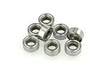 A cluster of eight small metal shielded ball bearings arranged on a white background.
