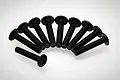 A set of ten black metal button head screws arranged in a semi-circle on a white background.