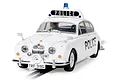 A 1/32 scale Scalextric Jaguar MK2 police slot car in white with a roof-mounted light bar and police markings, positioned on a slot car track.
