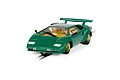 A 1/32 scale Scalextric Lamborghini Countach slot car in green with gold wheels, positioned on a piece of slot car track against a white background.