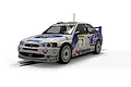 A 1/32 scale Scalextric Ford Escort WRC slot car in white and blue livery with number 7, displayed on a white background.