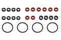 A collection of small black plastic spacers, red rubber O-rings, and larger black rubber O-rings for RC shock maintenance.