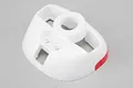 A white foam RC airplane cowling with a red accent on the side, featuring a central circular opening and several smaller cutouts.
