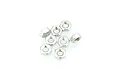 A cluster of eight small silver-coloured metal hex nuts arranged on a white background.