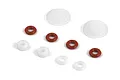 A collection of small RC shock rebuild parts including red O-rings, white plastic spacers, and two larger white plastic discs on a white background.
