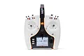 A front-facing studio shot of the white Spektrum NX7e+ 14-channel RC transmitter with an illuminated orange accent light and active LCD screen.