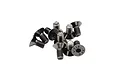 A small pile of dark grey metal countersunk hex head screws with visible 12.9 grade markings on the heads.