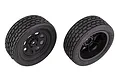 Two Team Associated RC street stock front tyres pre-glued onto black plastic wheels, viewed from different angles against a white background.
