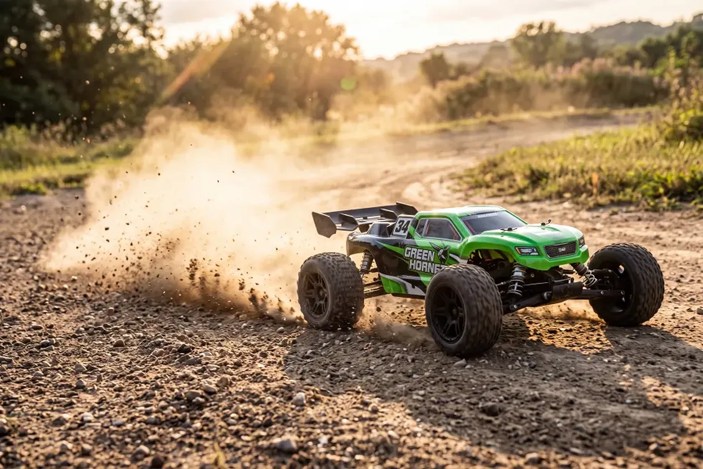 A green hobby-grade RC stadium truck kicking up dirt while speeding along an outdoor track.