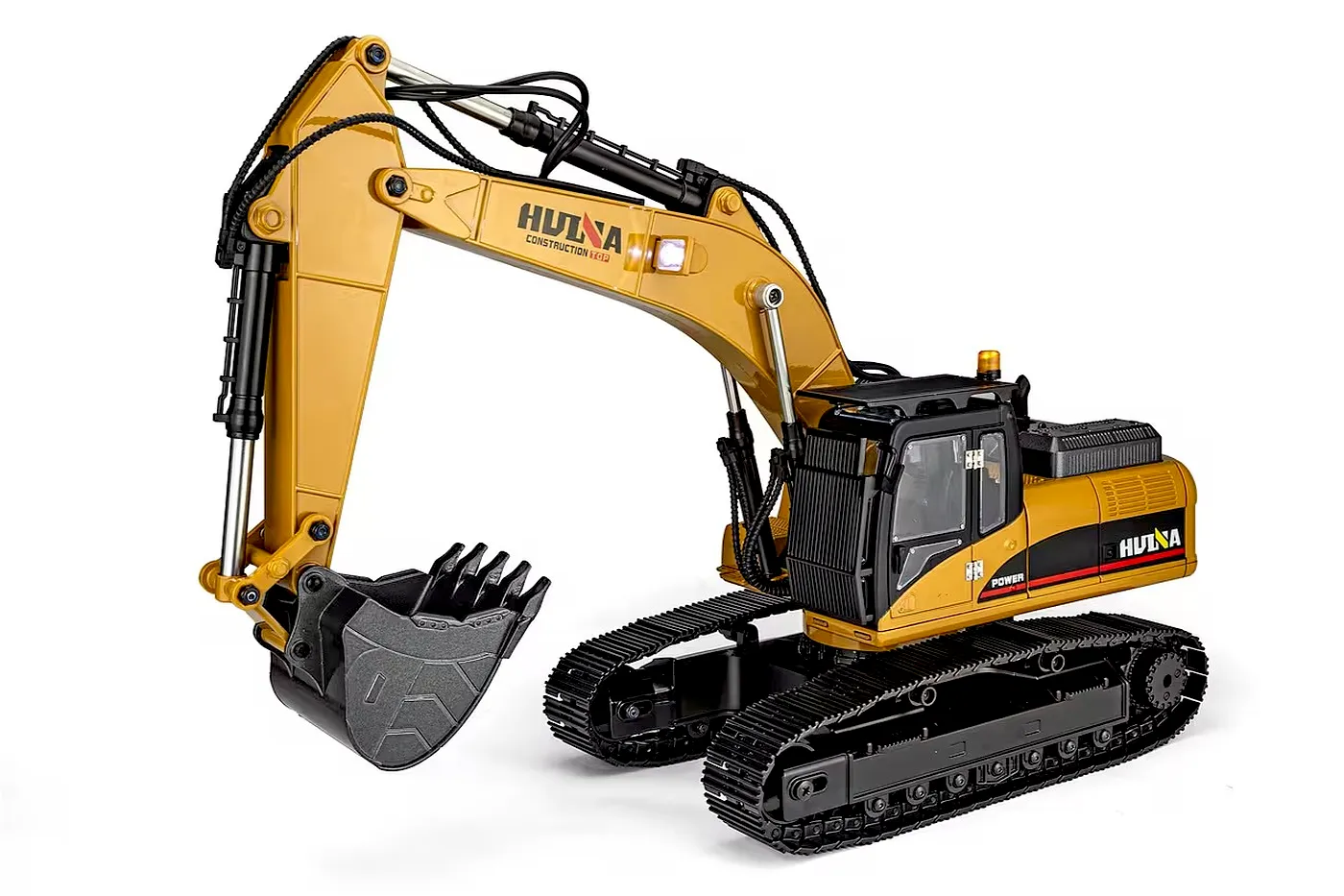A studio product shot of a yellow and black remote-controlled toy excavator featuring rubber tracks and a metal bucket.