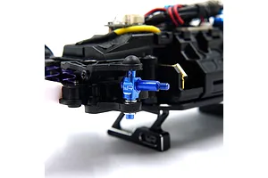 A close-up view of a blue anodized aluminium steering knuckle installed on an RC car chassis.