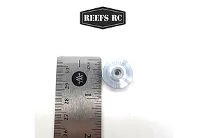 A silver aluminium winch spool for RC cars next to a metal ruler for scale, with the Reefs RC logo above.
