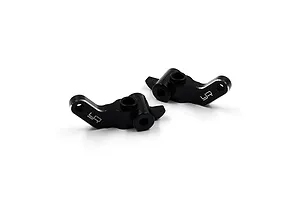Two black anodized aluminium RC steering hubs from Yeah Racing, featuring a machined finish and the YR logo.