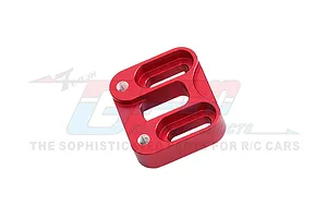 A red anodized aluminium RC car part with three elongated slots and two threaded mounting holes, viewed from an angle against a white background.