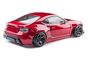 Rear three-quarter view of a shiny red MST RMX 2.5 86RBRC RC drift car on a white background.