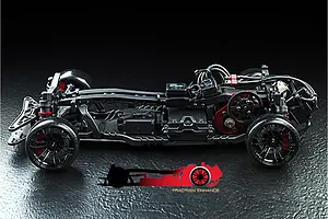 Side view of the MST RMX 2.5 RC drift car chassis showing the drivetrain, suspension, and electronics on a black background.