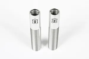 Two silver aluminium RC shock bodies with threaded exteriors and Icon Vehicle Dynamics logos, standing upright on a white background.