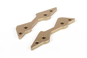 Two gold-anodized aluminium shock mount plates for an RC vehicle, shown from an angled perspective on a white background.