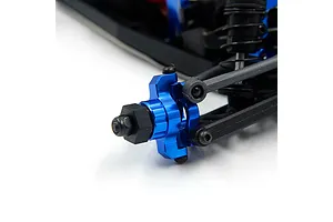 Close-up of a blue anodized aluminium RC car steering knuckle and wheel hex hub installed on a black plastic suspension arm.