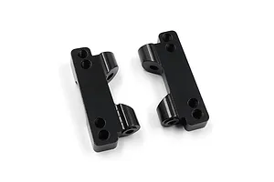 Two black anodized aluminium rear lower suspension arm mounts for RC cars, shown from an angled top-down perspective on a white background.